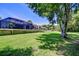Beautiful backyard with lawn and mature trees, pool, covered outdoor kitchen, and lounge area at 3212 Sunset Lakes Blvd, Land O Lakes, FL 34638