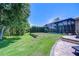 Expansive lawn with well-maintained landscaping, pool and lounging area at 3212 Sunset Lakes Blvd, Land O Lakes, FL 34638