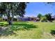 Spacious backyard with lush lawn and screened-in pool, perfect for outdoor activities and entertaining at 3212 Sunset Lakes Blvd, Land O Lakes, FL 34638