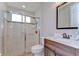 Bathroom with a glass-enclosed shower, decorative wood vanity, and modern fixtures at 3212 Sunset Lakes Blvd, Land O Lakes, FL 34638