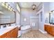 Bathroom featuring dual vanities, a tub, and a tiled walk-in shower at 3212 Sunset Lakes Blvd, Land O Lakes, FL 34638