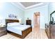 Spacious bedroom with wood flooring, a neutral color scheme, and an en suite bathroom at 3212 Sunset Lakes Blvd, Land O Lakes, FL 34638