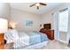 Cozy bedroom with ceiling fan, dresser, television, and window with curtain for natural light at 3212 Sunset Lakes Blvd, Land O Lakes, FL 34638