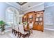 Beautiful dining room with lots of natural light, a wooden table, chairs, and a built-in hutch at 3212 Sunset Lakes Blvd, Land O Lakes, FL 34638