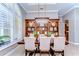 A dining area with a wood table, chairs, and a beautiful chandelier hangs above the table and hutch at 3212 Sunset Lakes Blvd, Land O Lakes, FL 34638