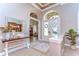 Bright entryway featuring tiled floor, decorative table, and arched doorways leading to other rooms at 3212 Sunset Lakes Blvd, Land O Lakes, FL 34638