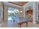 Game room with built-in bar, ping pong table, and sliding doors leading to the pool area at 3212 Sunset Lakes Blvd, Land O Lakes, FL 34638