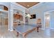 Entertain in this large game room with ping pong table, bar and unique ceiling design at 3212 Sunset Lakes Blvd, Land O Lakes, FL 34638