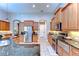 Spacious kitchen featuring stainless steel appliances, granite countertops, tile flooring, and lots of storage at 3212 Sunset Lakes Blvd, Land O Lakes, FL 34638