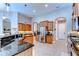 Well-equipped kitchen with stainless steel appliances, granite countertops, custom cabinetry, and tile flooring at 3212 Sunset Lakes Blvd, Land O Lakes, FL 34638