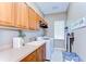Bright laundry room featuring cabinets, a utility sink, washer, dryer, and decor at 3212 Sunset Lakes Blvd, Land O Lakes, FL 34638
