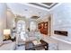Bright and spacious living room, complete with a fireplace, with a view of the dining room at 3212 Sunset Lakes Blvd, Land O Lakes, FL 34638