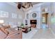 Open-concept living room with ceiling fans, fireplace, tile flooring, and comfortable seating at 3212 Sunset Lakes Blvd, Land O Lakes, FL 34638