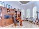 Executive office featuring custom built-ins, wood floors, a round table desk, and bright windows at 3212 Sunset Lakes Blvd, Land O Lakes, FL 34638