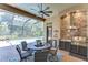 Enjoy the covered outdoor kitchen, complete with brick backsplash, stainless steel grill, mini fridge and seating area at 3212 Sunset Lakes Blvd, Land O Lakes, FL 34638