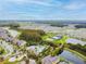 A wide aerial view displaying community pools, water features, parks, and numerous community homes at 32721 Brooks Hawk Ln, Wesley Chapel, FL 33543