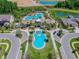 Aerial view of community pools and clubhouse, beautifully landscaped with sidewalks at 32721 Brooks Hawk Ln, Wesley Chapel, FL 33543