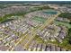 An aerial view showing community with landscaping, ponds, and well-maintained lawns at 32721 Brooks Hawk Ln, Wesley Chapel, FL 33543