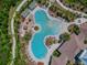 An aerial view of a community pool, with ample lounging space, cabanas and landscaping at 32721 Brooks Hawk Ln, Wesley Chapel, FL 33543