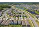 Aerial view of a beautiful community featuring ponds, manicured lawns, and well-maintained homes at 32721 Brooks Hawk Ln, Wesley Chapel, FL 33543