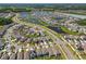 A community aerial view showing multiple ponds, landscaping, and neatly organized homes at 32721 Brooks Hawk Ln, Wesley Chapel, FL 33543