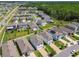 A neighborhood with well-maintained lawns, driveways, and varied home exteriors, seen from above at 32721 Brooks Hawk Ln, Wesley Chapel, FL 33543