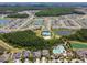 Aerial view of a Primary-planned community featuring well-maintained homes, picturesque lakes, resort-style amenities, and lush landscaping at 32721 Brooks Hawk Ln, Wesley Chapel, FL 33543