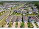 An aerial shot showing neighborhood homes with driveways, lawns, and community landscaping at 32721 Brooks Hawk Ln, Wesley Chapel, FL 33543
