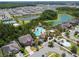Luxury community aerial view showcases resort-style pool, clubhouse, lakes, and residential homes surrounded by lush greenery at 32721 Brooks Hawk Ln, Wesley Chapel, FL 33543
