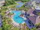 Aerial view of a resort-style pool and clubhouse amidst lush landscaping in the community at 32721 Brooks Hawk Ln, Wesley Chapel, FL 33543