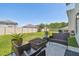 Spacious backyard patio featuring outdoor seating, planters, and a well-maintained lawn, perfect for relaxation and entertaining at 32721 Brooks Hawk Ln, Wesley Chapel, FL 33543