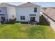 Aerial view of backyard featuring a patio, lawn and rear exterior of home at 32721 Brooks Hawk Ln, Wesley Chapel, FL 33543