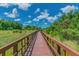 A wooden boardwalk extends through serene greenery, creating an inviting outdoor pathway at 32721 Brooks Hawk Ln, Wesley Chapel, FL 33543