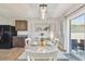 Cozy dining area featuring an sliding glass door, and modern lighting at 32721 Brooks Hawk Ln, Wesley Chapel, FL 33543
