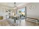 Well-lit dining area with wood floors, table, and sliding glass doors to backyard at 32721 Brooks Hawk Ln, Wesley Chapel, FL 33543
