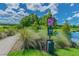 A dog waste station next to a scenic community walking path encourages responsible pet ownership at 32721 Brooks Hawk Ln, Wesley Chapel, FL 33543