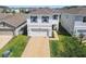 Charming two-story home with a well-manicured lawn and a two-car garage, showcasing curb appeal and functionality at 32721 Brooks Hawk Ln, Wesley Chapel, FL 33543