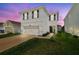 Charming two-story home features a two car garage and a well maintained lawn in a suburban neighborhood at 32721 Brooks Hawk Ln, Wesley Chapel, FL 33543