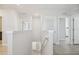 Bright hallway featuring neutral paint, recessed lighting, and wood-look flooring, creating a clean and modern transition space at 32721 Brooks Hawk Ln, Wesley Chapel, FL 33543
