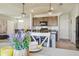 Bright kitchen featuring stainless steel appliances, center island, and modern lighting fixtures at 32721 Brooks Hawk Ln, Wesley Chapel, FL 33543