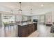 Open concept kitchen and living area with large center island, perfect for entertaining guests at 32721 Brooks Hawk Ln, Wesley Chapel, FL 33543