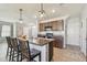 Modern kitchen featuring stainless steel appliances, center island, and stylish pendant lighting at 32721 Brooks Hawk Ln, Wesley Chapel, FL 33543