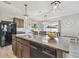 Spacious kitchen island with barstool seating and stainless steel appliances at 32721 Brooks Hawk Ln, Wesley Chapel, FL 33543