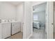 Laundry room with new appliances, next to the door to the main bedroom and bathroom at 32721 Brooks Hawk Ln, Wesley Chapel, FL 33543