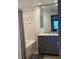 Bathroom featuring shower, tub and granite countertop vanity with storage at 402 S Armenia Ave # 127, Tampa, FL 33609