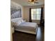 Bedroom featuring hardwood floors and a large window for natural light at 402 S Armenia Ave # 127, Tampa, FL 33609