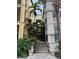Inviting entrance with lush tropical landscaping and walkway to the building's front door at 402 S Armenia Ave # 127, Tampa, FL 33609