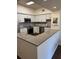 Bright kitchen featuring stainless steel appliances, granite countertops, and white cabinets at 402 S Armenia Ave # 127, Tampa, FL 33609