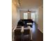 Open-concept living room with hardwood floors, ceiling fan, and lots of natural light at 402 S Armenia Ave # 127, Tampa, FL 33609