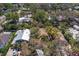 Aerial image displaying the home's setting among mature trees and other residences at 407 Indiana Ave, Crystal Beach, FL 34681